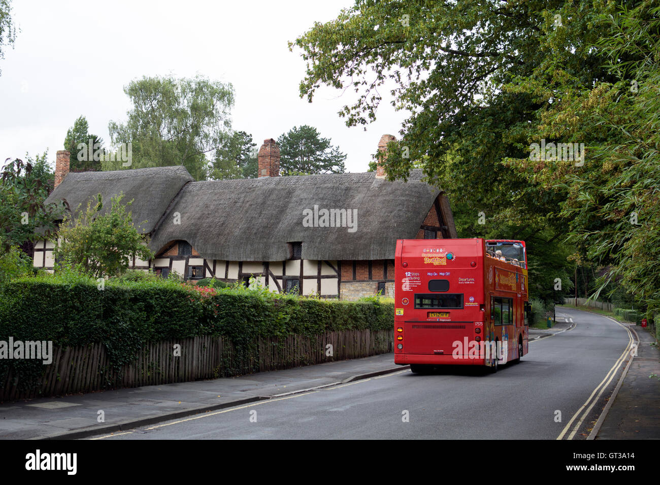 Stagecoach open top bus tour passing Anne Hathaway`s Cottage, Shottery, Warwickshire, UK Stock Photo